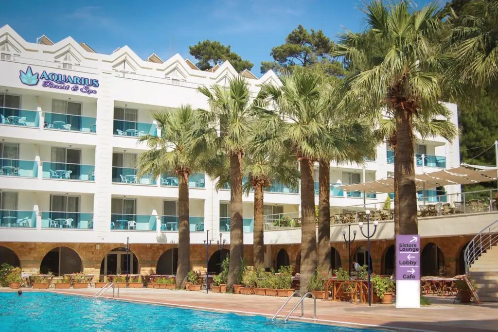 Aquarius Resort and Spa outdoor pool and building daytime. Branding mock-up.