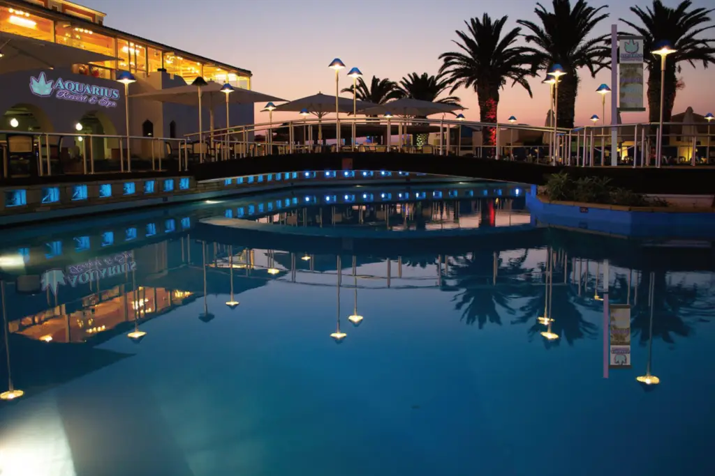 Aquarius Resort and Spa outdoor pool and building nighttime. Branding mock-up.