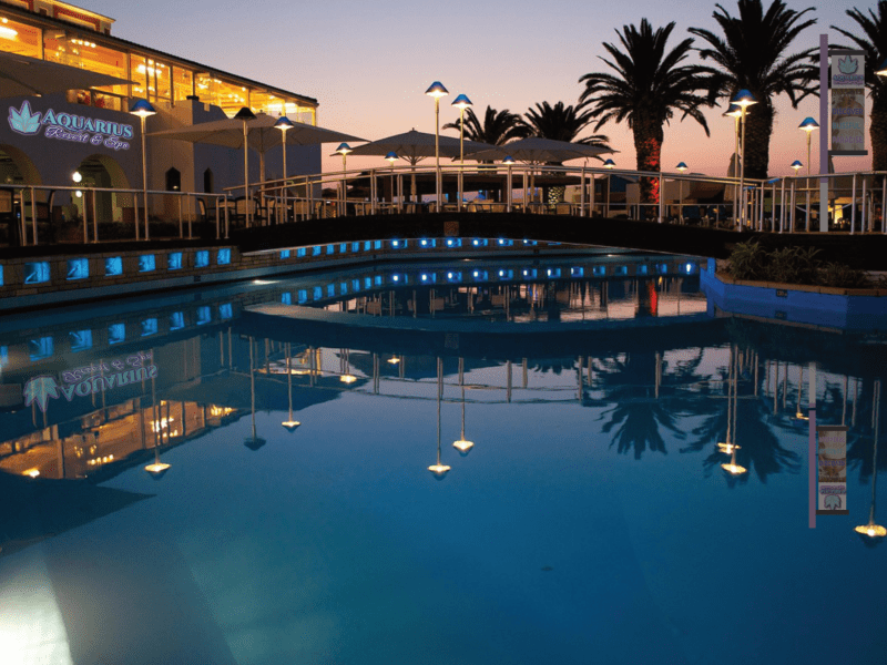 Aquarius Resort and Spa outdoor pool and building nighttime. Branding mock-up.