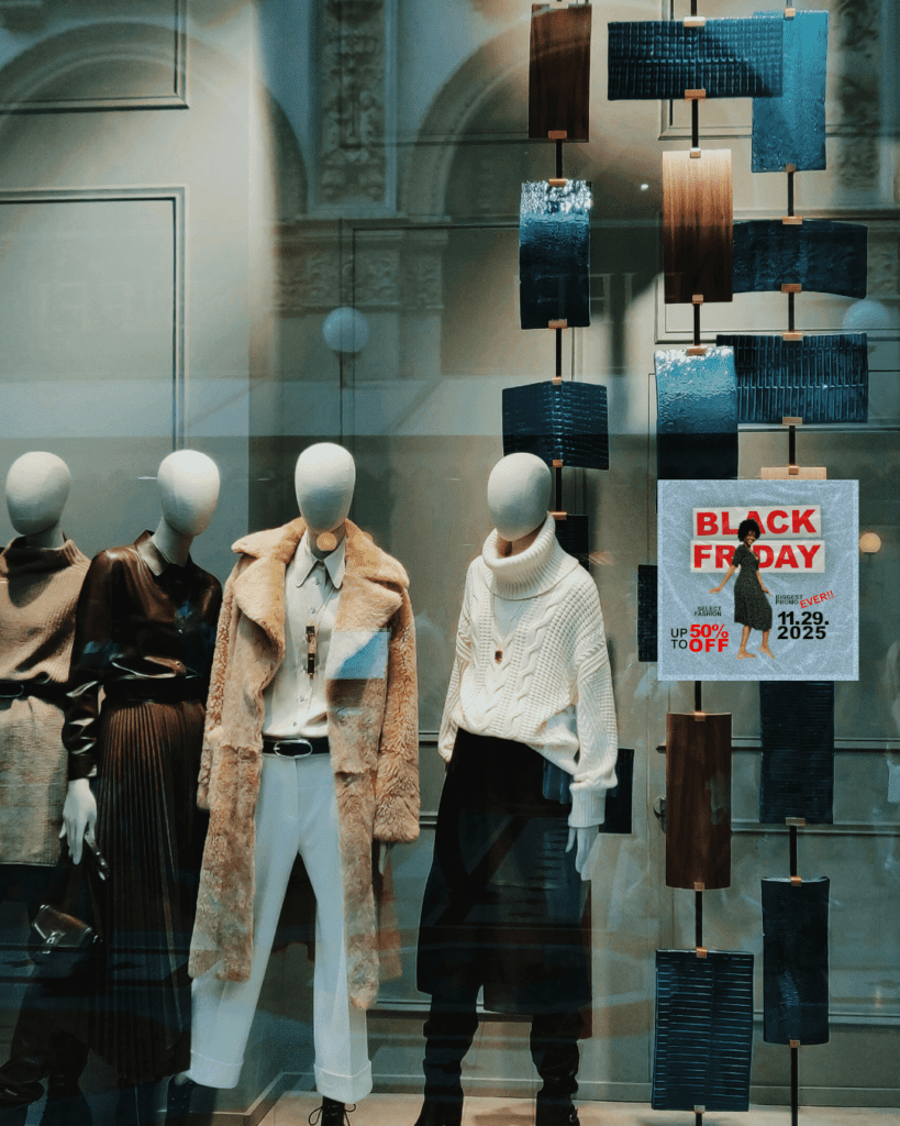 Black Friday poster mock-up in store window with mannequin display. Promotional graphic design.