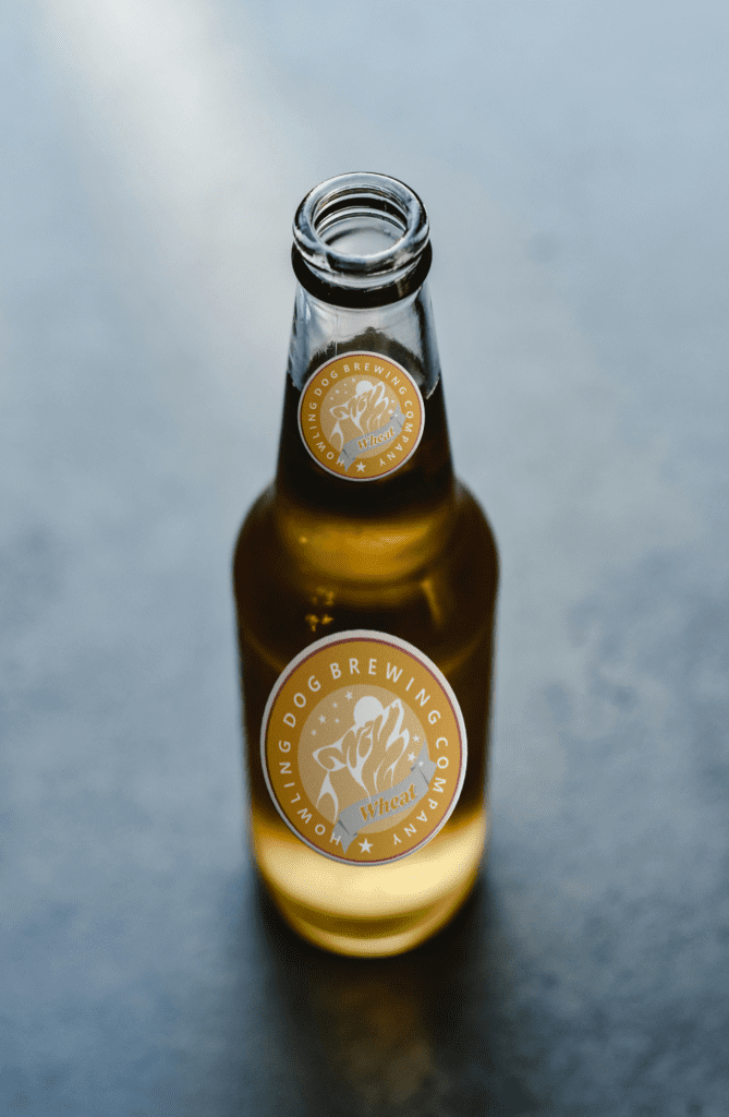 Howling Dog Brewing wheat logo mock-up on beer bottle. Logo design.
