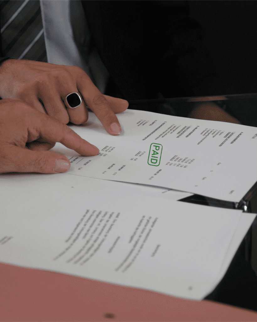 Paid stamp mock-up on table with papers. Graphic design.