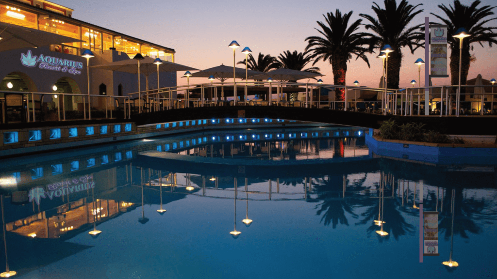Aquarius Resort and Spa outdoor pool and building nighttime. Branding mock-up.