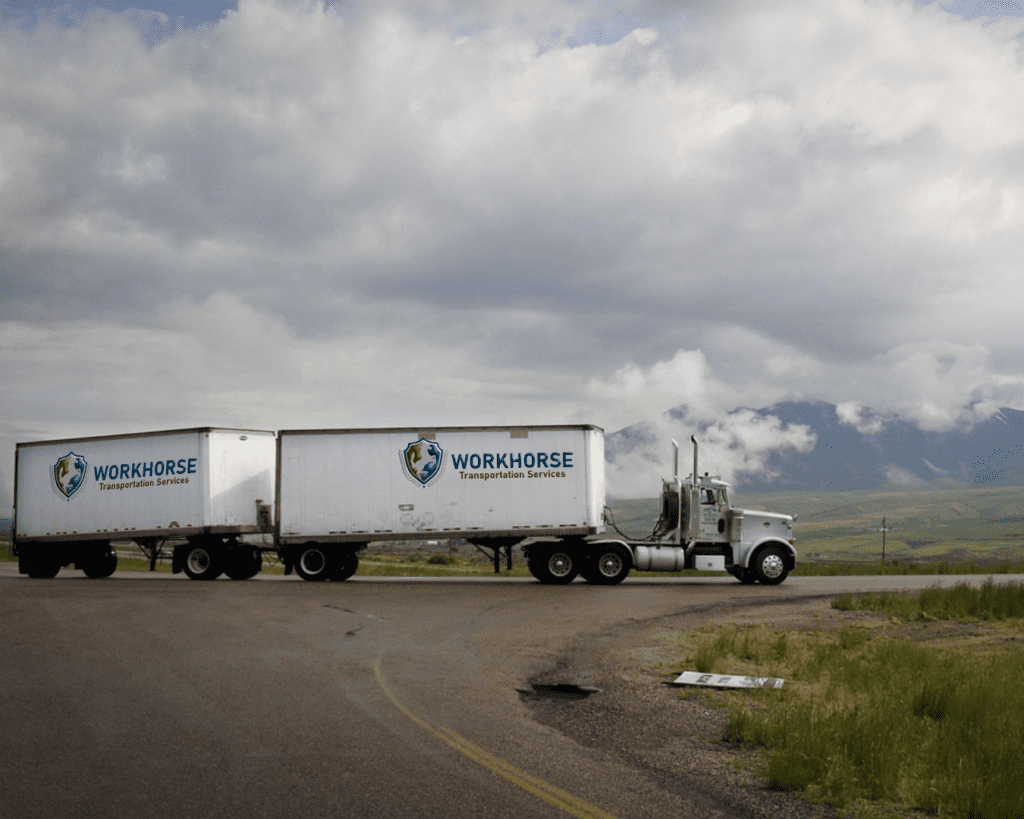 Workhorse Transportation Services truck mock-up 5 on rural road junction. Branding design.